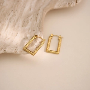 Detail of 18k gold plated rectangular earrings with vintage Greek Key relief pattern
