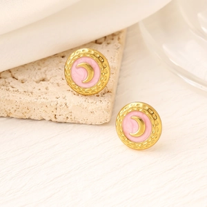 Detail of round gold earrings with pink enamel inlay and crescent moon pattern