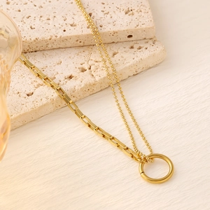 Detailed macro view of 18K gold-plated double-layer chain necklace with circle pendant