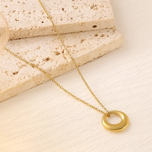 Minimalist 18K gold plated titanium necklace with polished ring pendant on stone stand