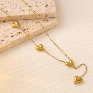 Elegant 18K gold plated titanium necklace featuring four solid heart-shaped charms