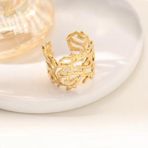 Close-up of 18K gold-plated irregular hollow ring with natural coral-like branch texture