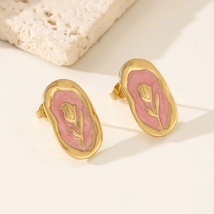 Detail of vintage oval gold earrings with pink enamel and tulip flower relief