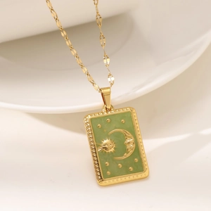 Gold rectangular tarot sun and moon pendant necklace with light green enamel detail