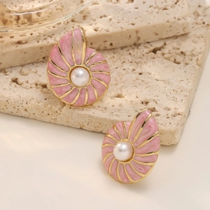 Close-up of pink conch stud earrings with gold shell texture and white pearls