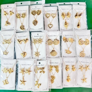 Detailed flat lay of assorted vintage stainless steel necklace and earring jewelry sets