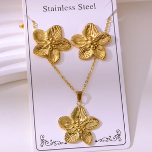 Macro shot of gold-plated stainless steel floral necklace and earrings jewelry set