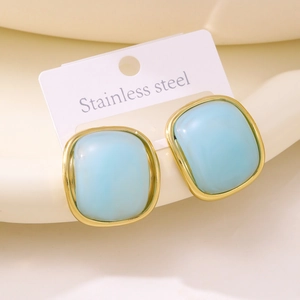 Detail of square light blue resin earrings with gold-plated stainless steel edges