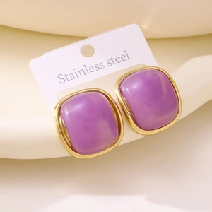 Close-up of square purple resin earrings with gold stainless steel edges