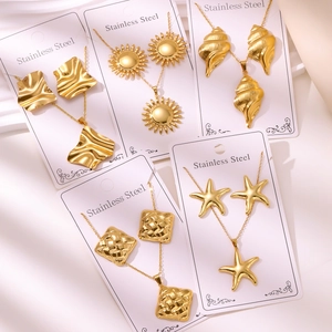 Detailed set of 18K gold plated stainless steel jewelry featuring sun and shell motifs