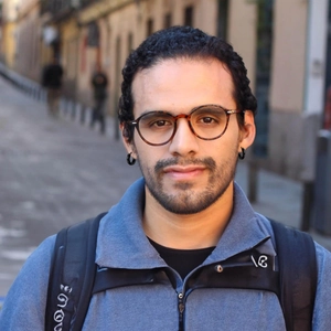 Men's minimalist black hoop earrings in matte finish worn for daily street style
