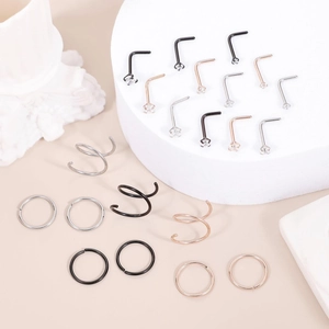 Detailed set of silver black and rose gold stainless steel nose rings with zircon inlays