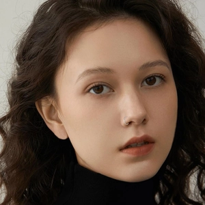 Close-up of a silver stainless steel nose ring hoop on a model with a minimalist design