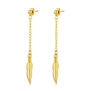 Detail of gold feather dangle earrings with delicate metal chains and textured leaf charms