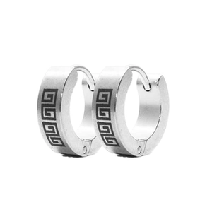 Close-up of polished stainless steel hoop earrings with black Greek meander patterns