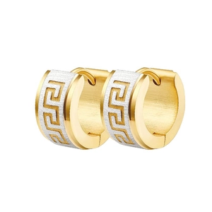 Detail of gold and silver hoop earrings with Greek key pattern and brushed metal finish