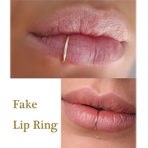 Detail of a golden non-piercing fake lip ring shown on a lower lip for realistic styling