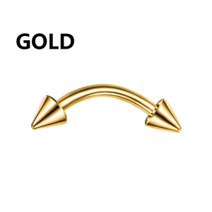Macro detail of a curved gold stainless steel barbell with sharp spike ends