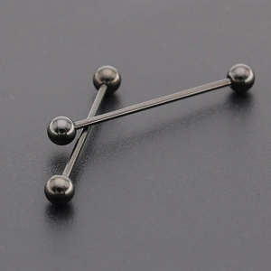 Gros plan de deux piercings industriel gris foncé avec finition métallique polie