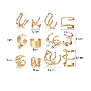Detailed view of 12 gold non-piercing ear cuffs with crystals and wave patterns