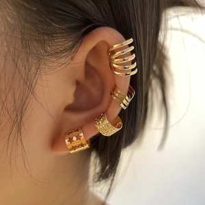 Set of four gold-plated stainless steel ear cuffs featuring celestial and textured designs