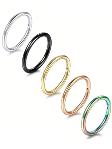 Detailed set of five polished stainless steel clicker rings in various vibrant metallic finishes