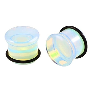 Macro detail of translucent opal glass ear plugs with black O-ring secure fixings