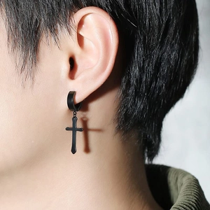 Close-up of black stainless steel cross earring on ear showing sleek punk style detail