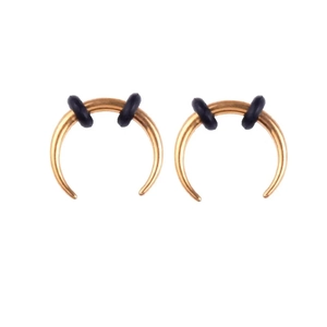 Detail view of golden stainless steel septum rings with black rubber fixation rings