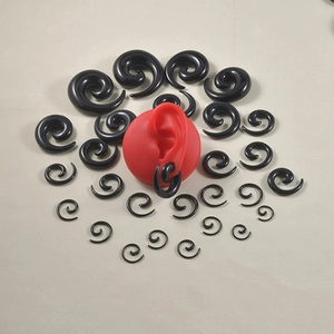 Set aus schwarzen Acryl-Spiral-Dehnstäben und Plugs in verschiedenen Größen mit Ohrmodell