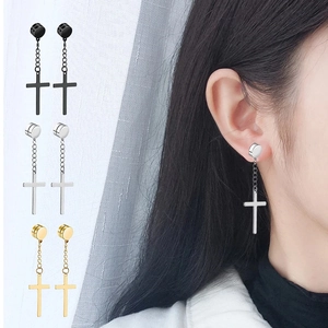 Cross pendant magnetic earring on model ear showing minimalist stainless steel design