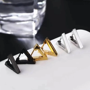 Minimalist geometric triangle huggie earrings in polished black, gold, and silver finishes