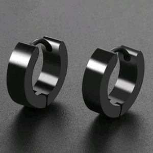Close-up of polished black stainless steel huggie earrings with high gloss finish