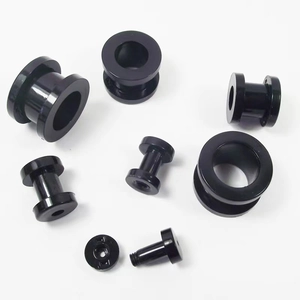 Detailed macro view of black stainless steel ear tunnels with precision screw threading