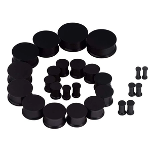 Macro display of black silicone ear tunnels and barbell piercing set in various sizes