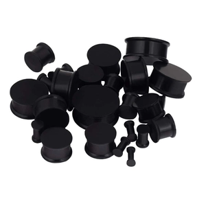 Detailed view of black solid saddle ear gauges in various sizes for ear stretching