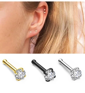 Detail view of 0.8mm 4-claw zircon nose studs in gold, black, and silver steel finishes