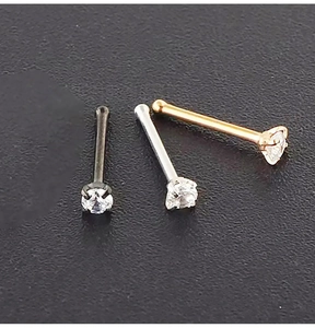 Detailed view of three 4-prong zircon nose studs in black, silver, and rose gold finishes
