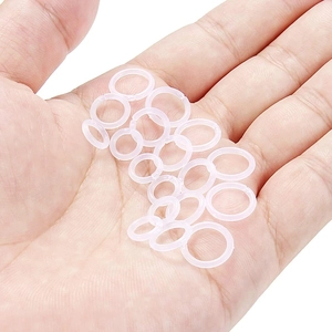 12-piece clear acrylic nose ring set for invisible piercings shown on a palm