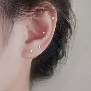 Classic 4-claw cubic zirconia nose studs set in stainless steel on a model