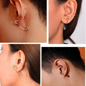 Détail de boucles d'oreilles épingle de nourrice dorées, argentées et noires