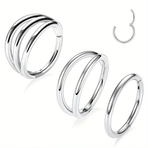Macro detail of silver stainless steel clicker rings in single, double, and triple hoop designs