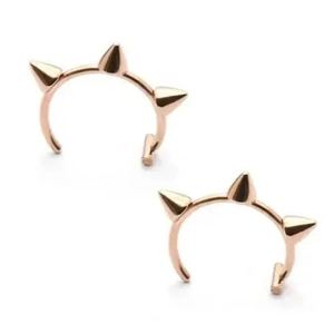 Rose gold punk style clip-on lip rings with three spiked studs on white background