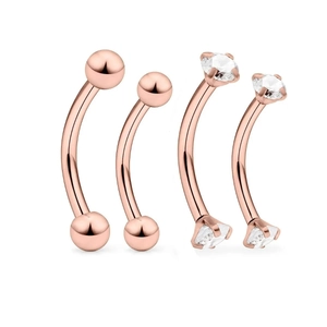 Close-up of four rose gold curved eyebrow rings with round balls and zircon settings