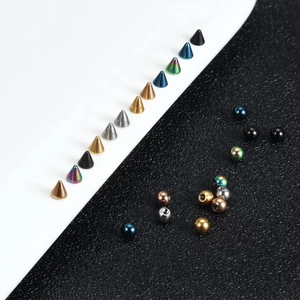 Detailed close-up of multi-colored stainless steel piercing studs and threaded beads