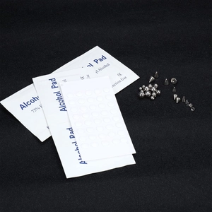Macro detail of 68-piece stainless steel faux piercing set with cones and alcohol pads