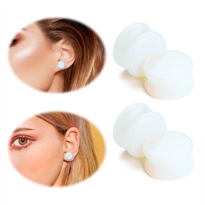 Macro view showing double flared white translucent silicone ear plugs on white background