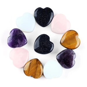 Macro detail of heart-shaped stone ear plugs in various polished semi-precious crystals