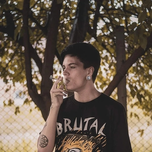 Male model wearing stainless steel ear gauges and street style t-shirt in outdoor setting