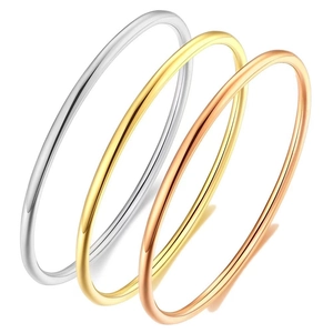 Detailed view of three stacked 3mm titanium steel rings in gold, silver, and rose gold